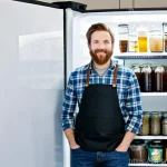 수제맥주 온도 조절법 - **Prompt:** A focused homebrewer, mid-30s, wearing a clean, dark apron over a casual long-sleeved sh...